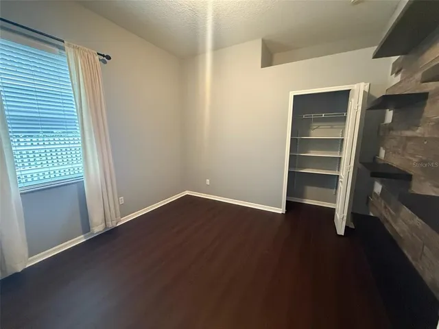 an empty room with wooden floor