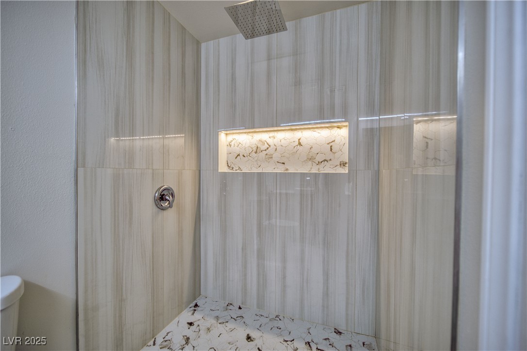 561 Jarvis Road Pahrump, NV 89060 - Photo 27 of 64 Rain-head fixture. Recessed shower storage w/ mult-color remote controlled lighting.