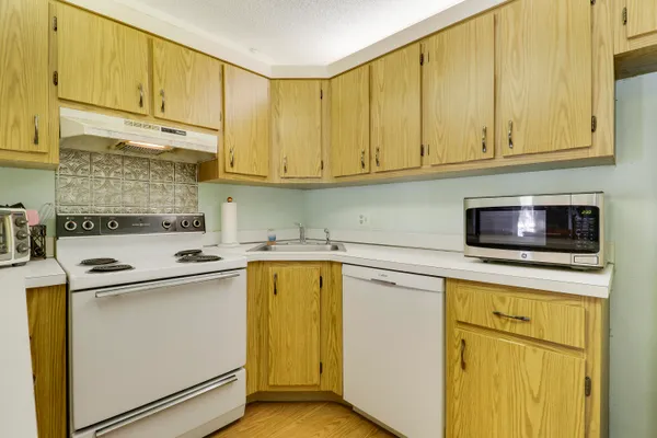 a kitchen with stainless steel appliances granite countertop a sink and a microwave