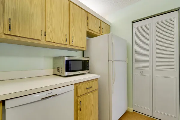 a kitchen with stainless steel appliances white cabinets and a refrigerator