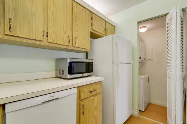 a kitchen with stainless steel appliances white cabinets and a refrigerator
