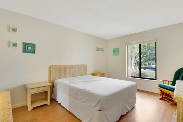 a bedroom with a bed chair and a window