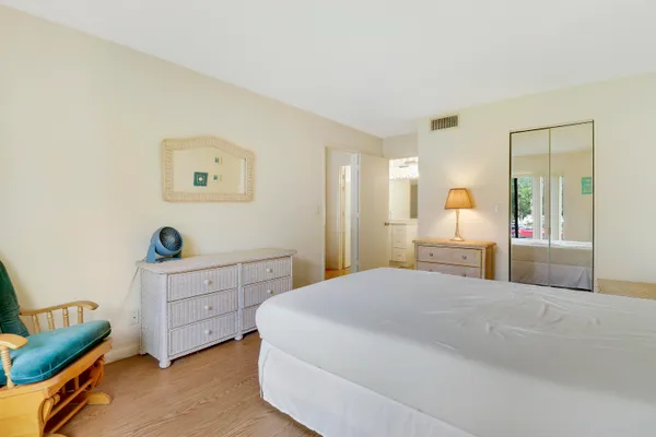 a spacious bedroom with a bed and a window