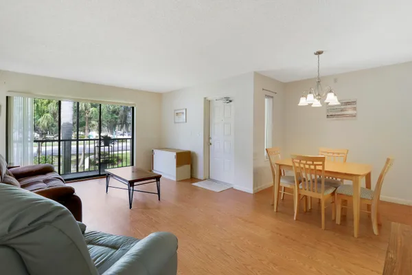 a living room with furniture and a floor to ceiling window