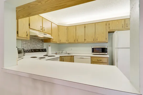 a kitchen with stainless steel appliances a refrigerator and stove