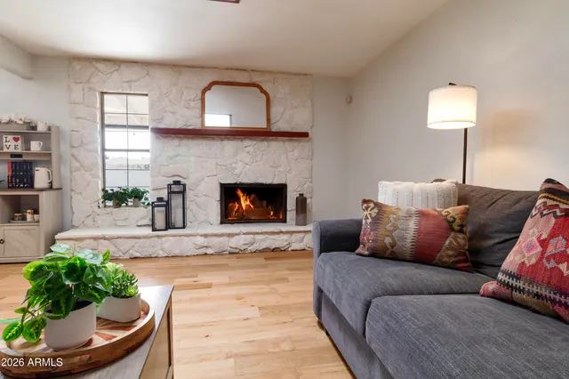 a living room with furniture and a fireplace