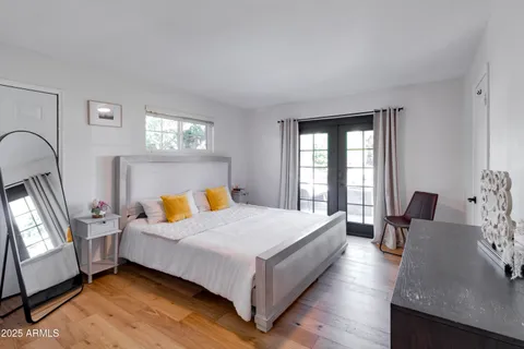 a bedroom with a bed dresser and a window