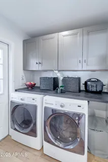 a view of a patio with a dining table and chairs with wooden floor