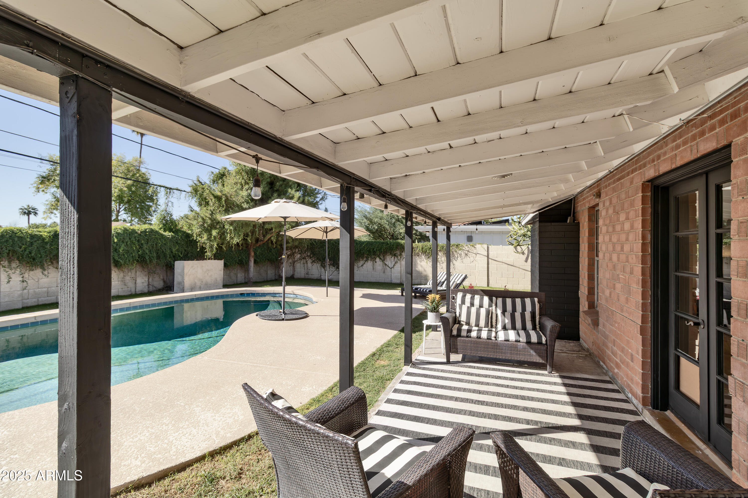 1903 East Palo Verde Drive Phoenix, AZ 85016 - Photo 21 of 25 a view of a patio with a dining table and chairs with wooden floor