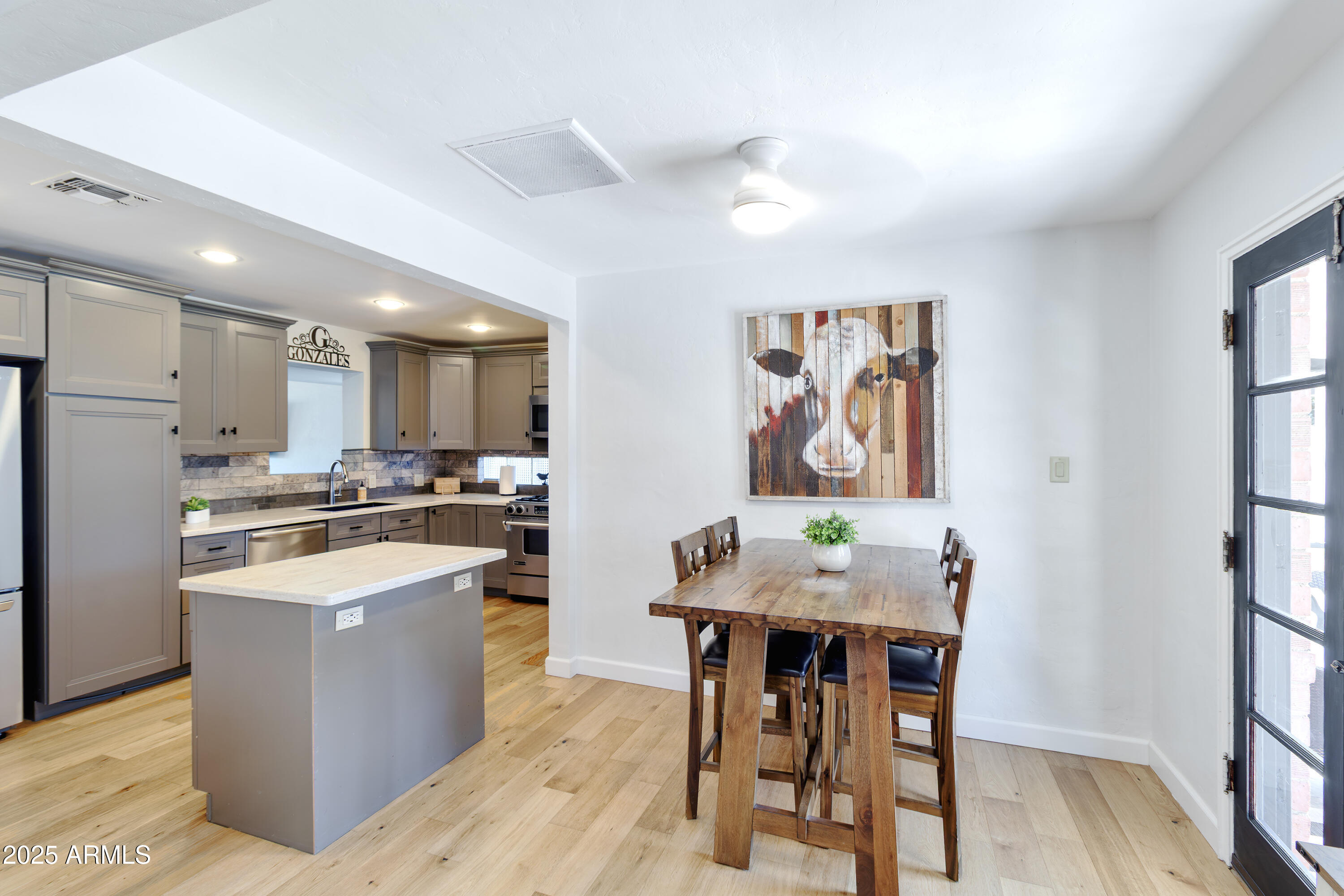 1903 East Palo Verde Drive Phoenix, AZ 85016 - Photo 7 of 25 a living room with stainless steel appliances kitchen island granite countertop furniture and wooden floor