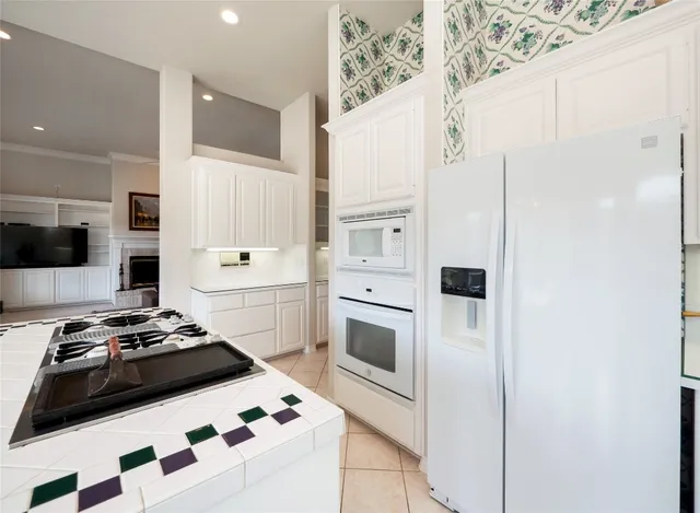 a kitchen with stainless steel appliances a white stove top oven and a chimney