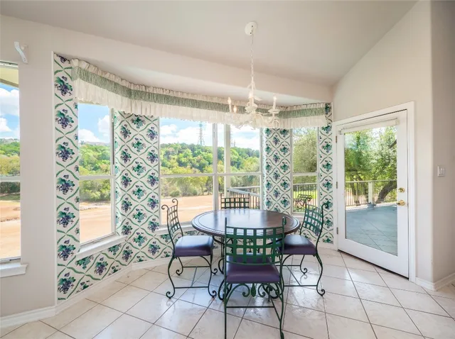 a view of a dining room with furniture window and outside view