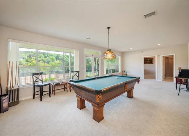 a view of living room filled with furniture and floor to ceiling window