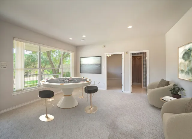 a room with pool table and windows