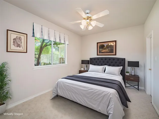 a very nice looking room with a chandelier fan