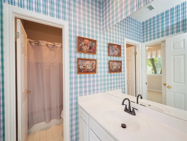 a bedroom with bed and a window