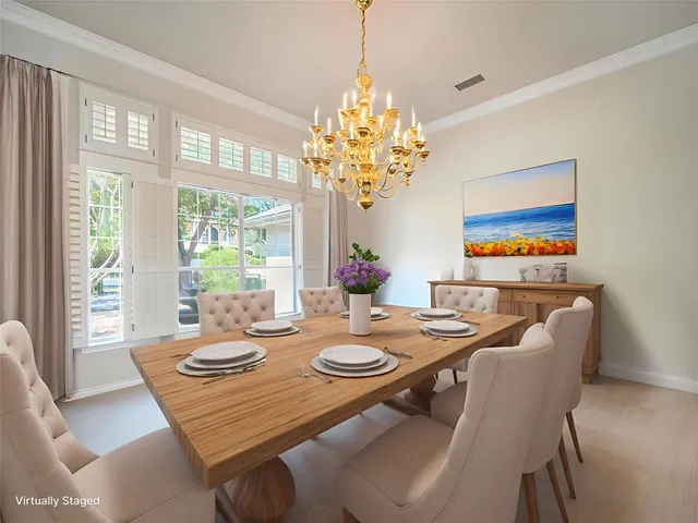 a view of a dining room with furniture wooden floor and chandelier