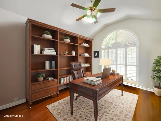 a living room with furniture and a book shelf