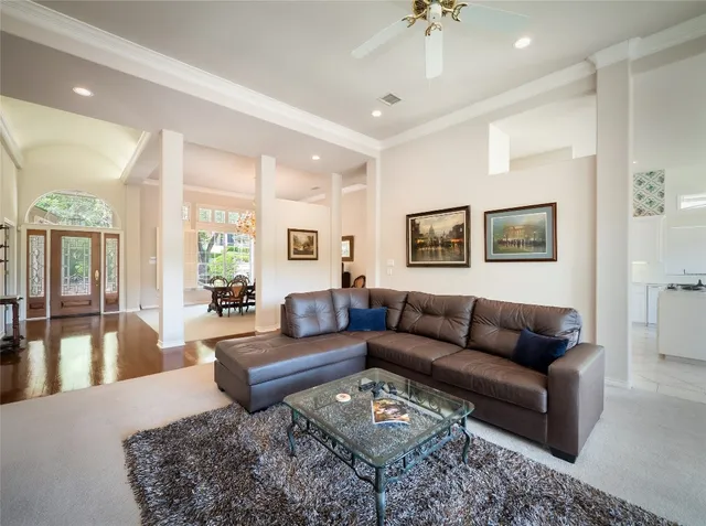 a living room with furniture a rug and a chandelier