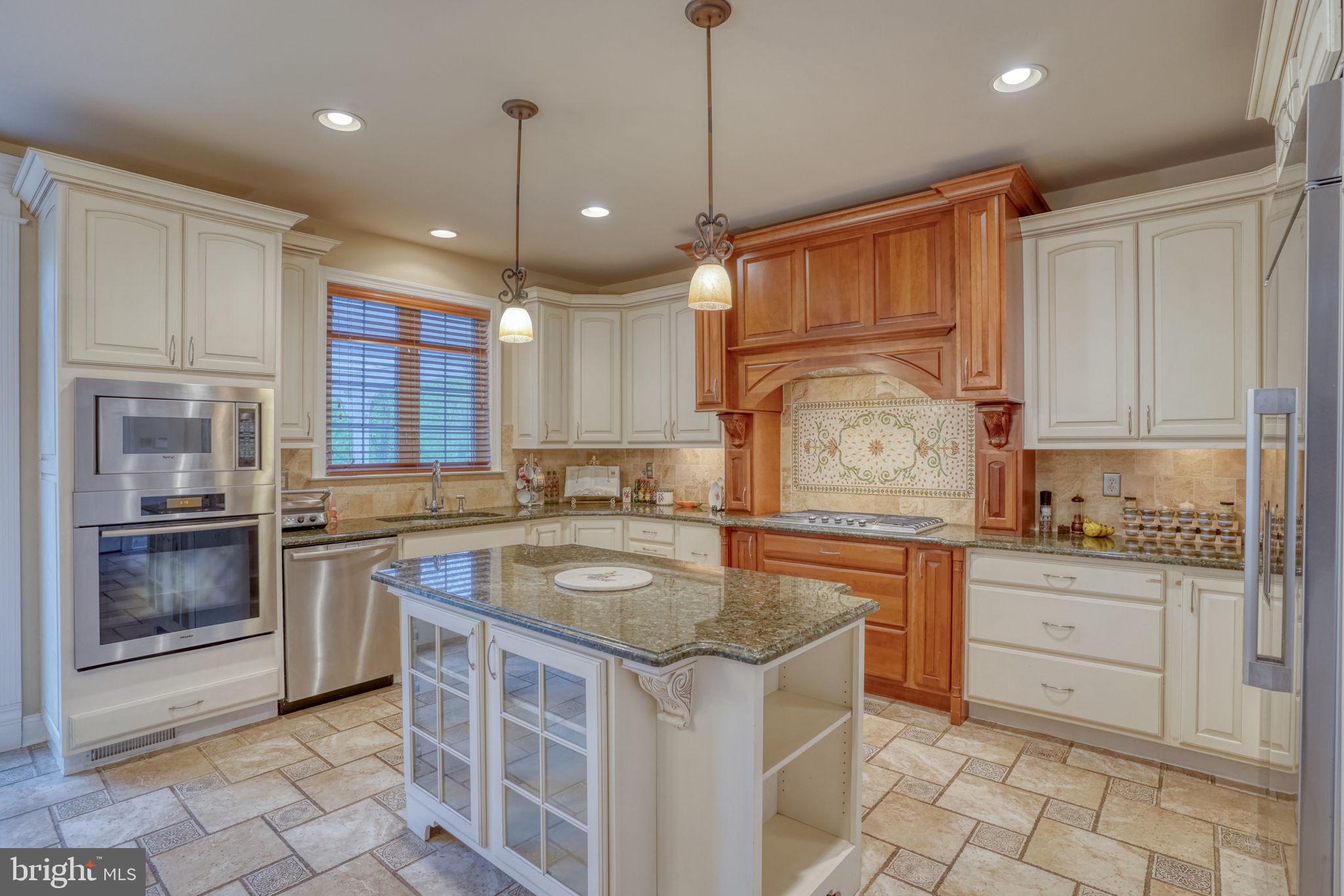 357 Willits Way Garnet Valley, PA 19060 - Photo 21 of 63 a kitchen with kitchen island granite countertop a stove top oven a sink and dishwasher