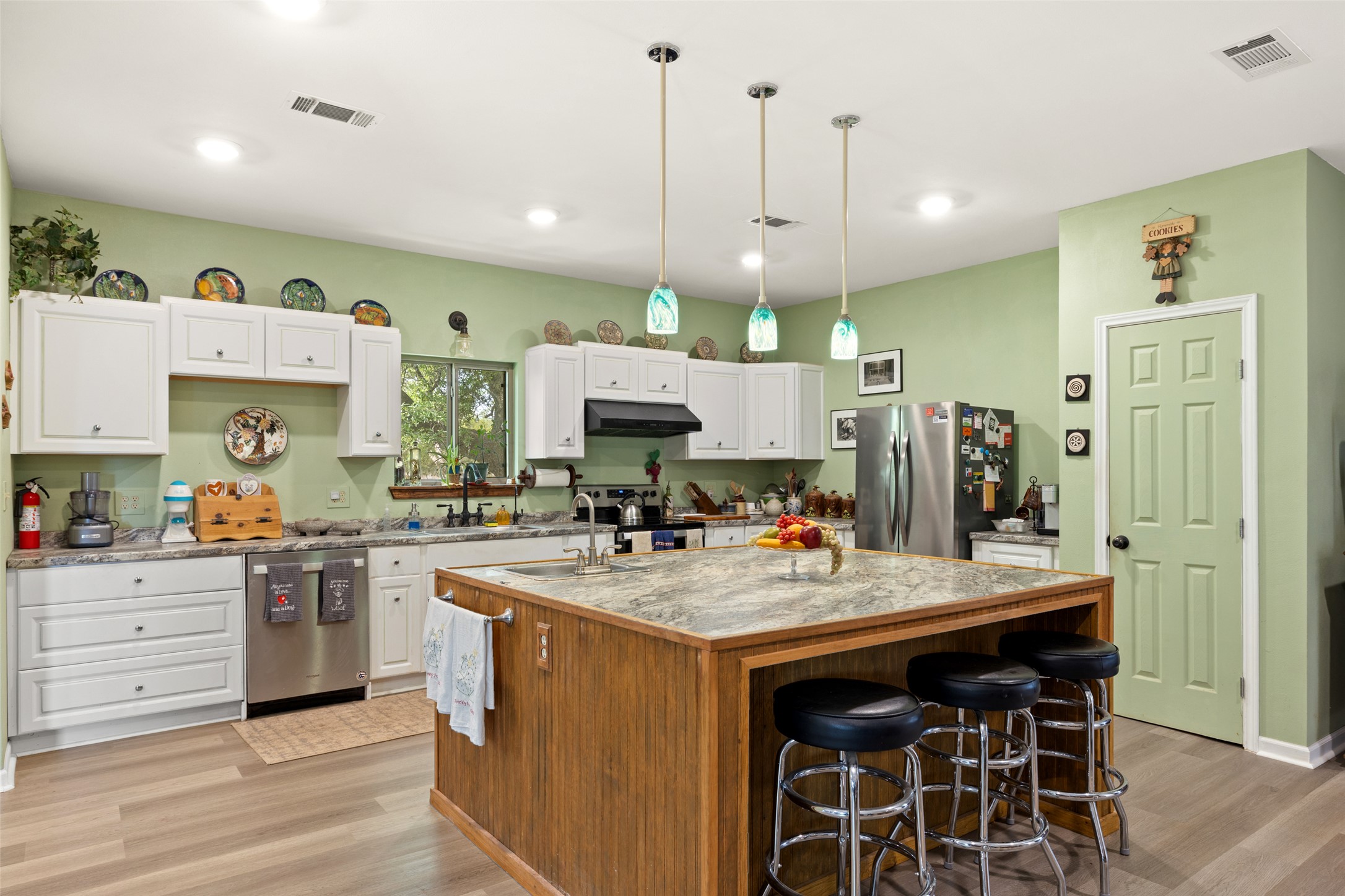 2966 Rm 165 Dripping Springs Dripping Springs, TX 78620 - Photo 7 of 23 Kitchen featuring an expansive center island with a stone countertop, white cabinetry with brushed nickel hardware, stainless steel appliances, and recessed lighting
