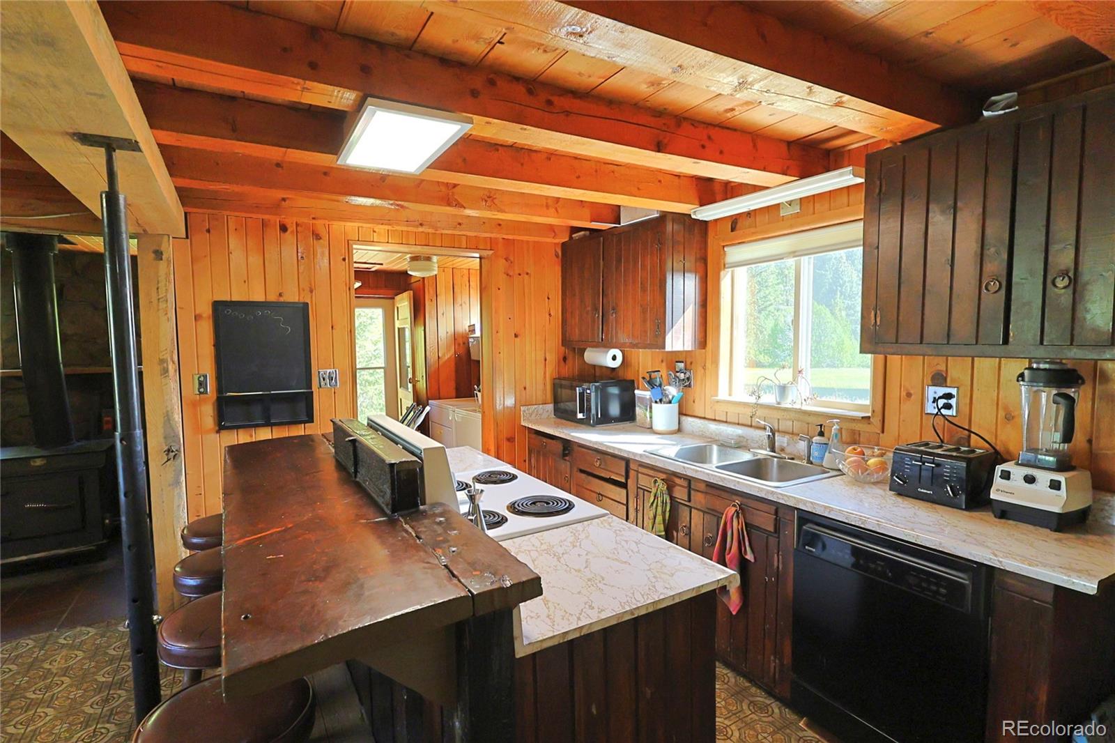 420 Quartz Lane Pitkin, CO 81241 - Photo 11 of 40 a kitchen with a sink a stove and cabinets
