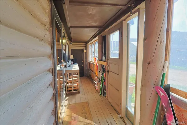 a view of a hallway with wooden floors and stairs