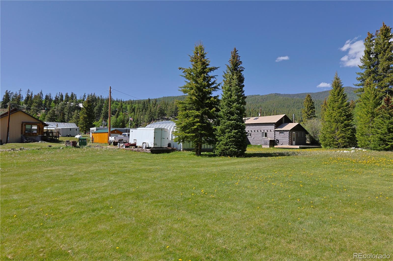 420 Quartz Lane Pitkin, CO 81241 - Photo 25 of 40 a front view of a house with a garden and trees