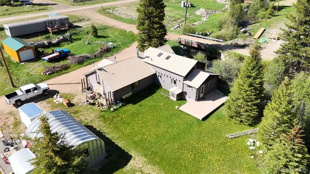 an aerial view of residential house with outdoor space and swimming pool