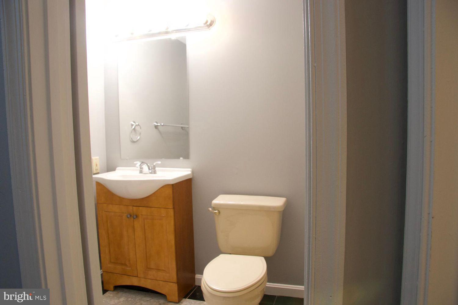 1831 Tilletson Place Woodbridge, VA 22191 - Photo 13 of 18 a bathroom with a sink a toilet and mirror