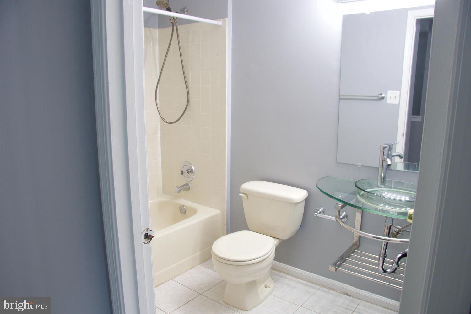 1831 Tilletson Place Woodbridge, VA 22191 - Photo 14 of 18 a bathroom with a granite countertop toilet a sink and a bathtub