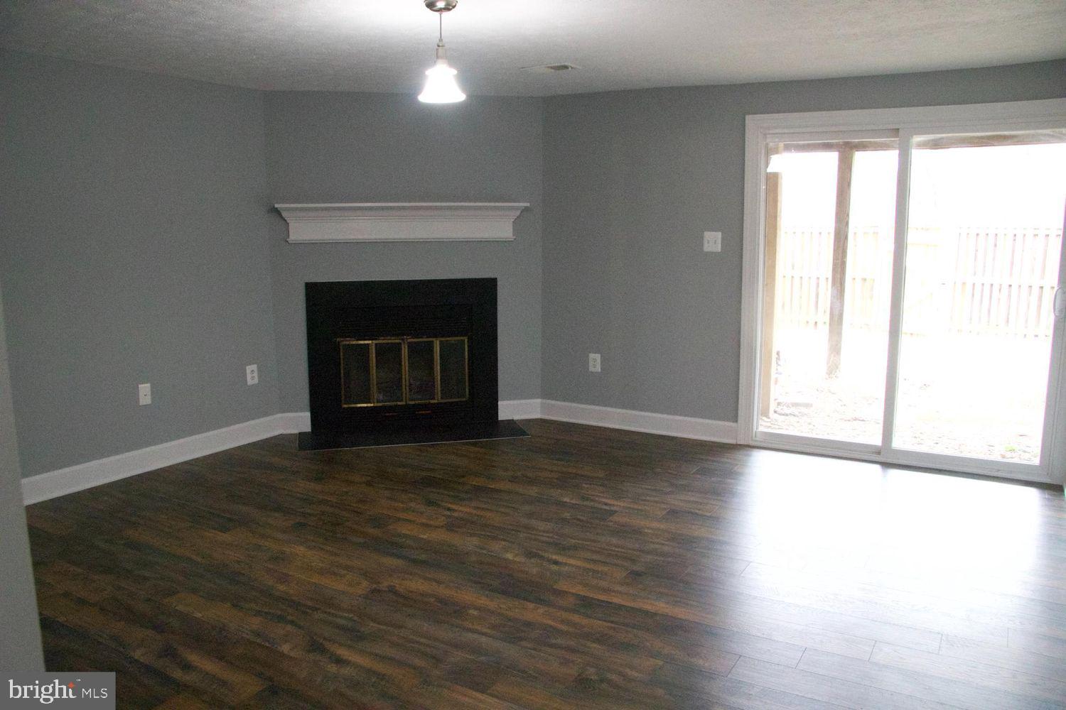 1831 Tilletson Place Woodbridge, VA 22191 - Photo 2 of 18 a view of an empty room with wooden floor and a window
