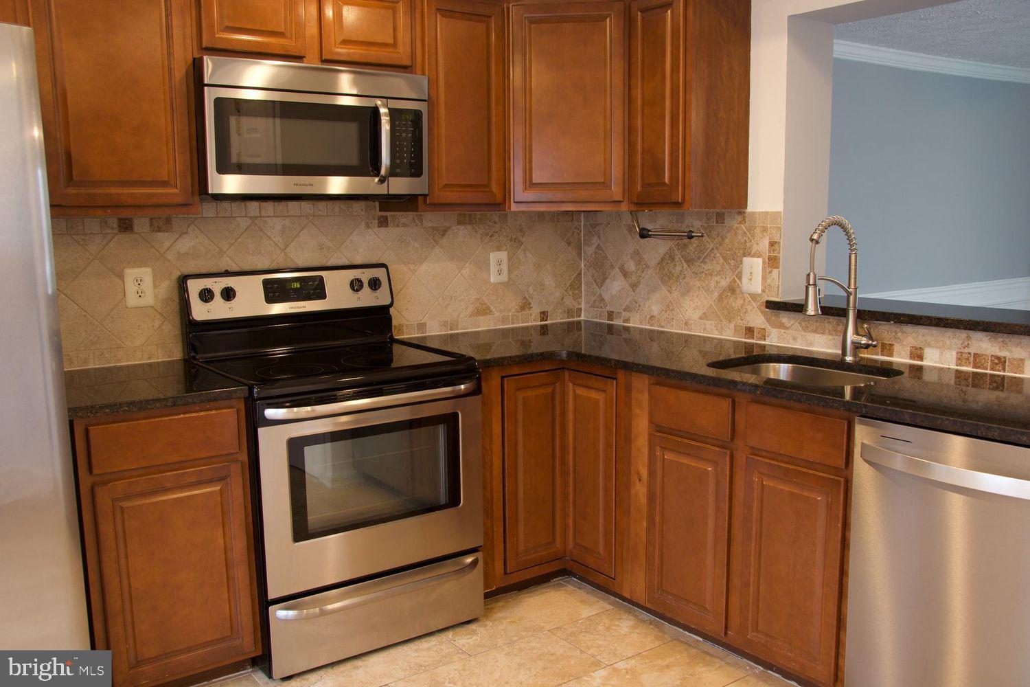 1831 Tilletson Place Woodbridge, VA 22191 - Photo 9 of 18 a kitchen with stainless steel appliances a stove microwave and sink