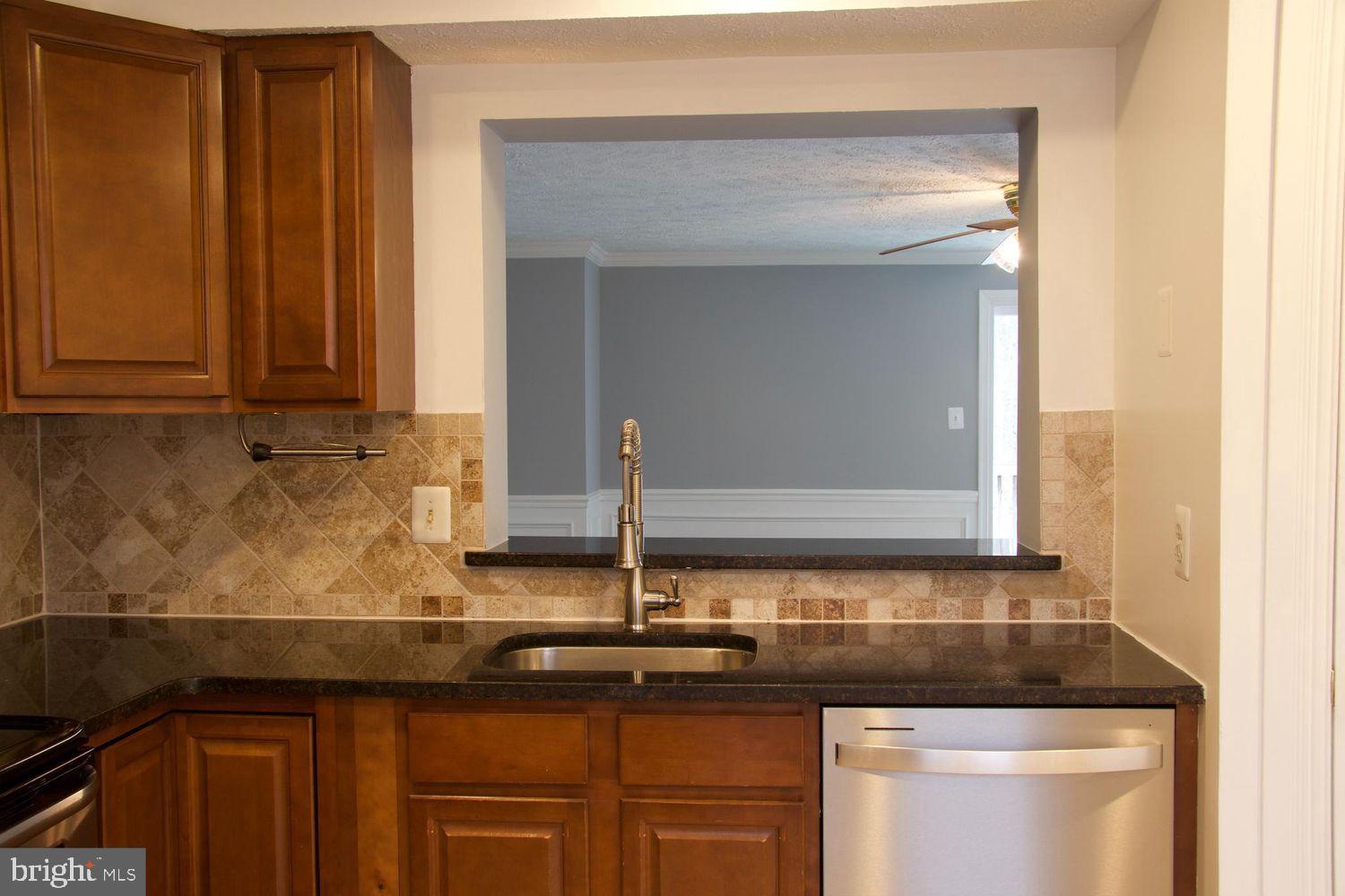 1831 Tilletson Place Woodbridge, VA 22191 - Photo 10 of 18 a kitchen with granite countertop a sink and cabinets