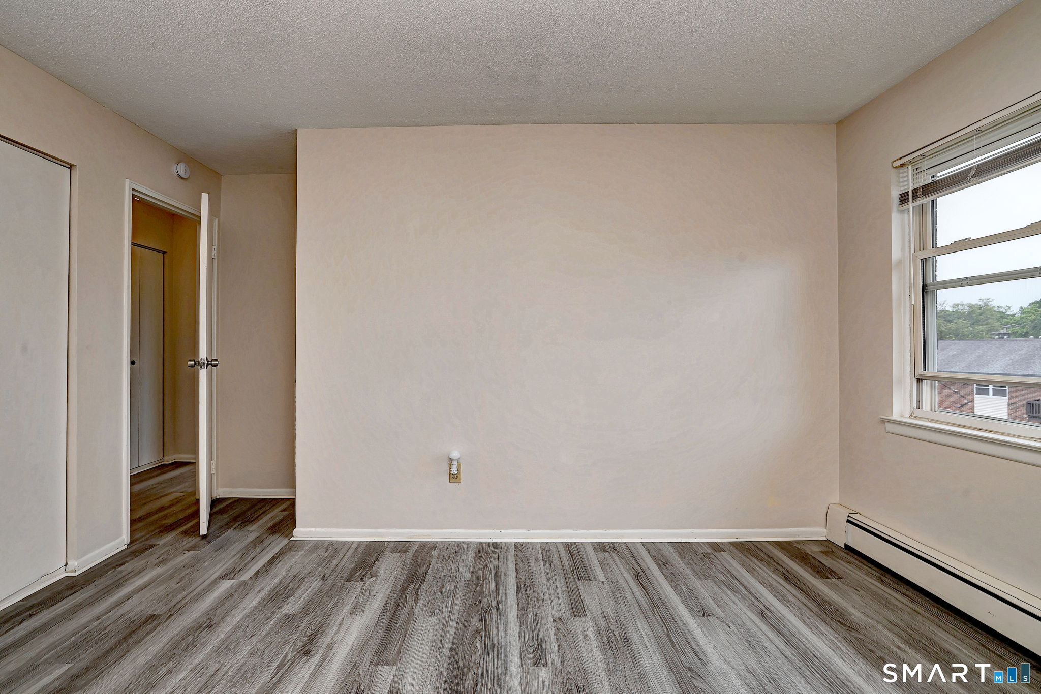 43 Balance Rock Road, Unit 11 Seymour, CT 06483 - Photo 27 of 40 an empty room with wooden floor and windows