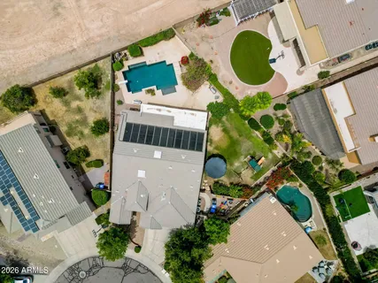 an aerial view of a house with a yard and lake view