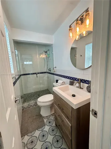 a bathroom with a sink toilet and mirror