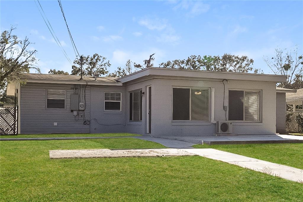 4243 Cynthia Street Orlando, FL 32811 - Photo 14 of 16 a front view of a house with a yard