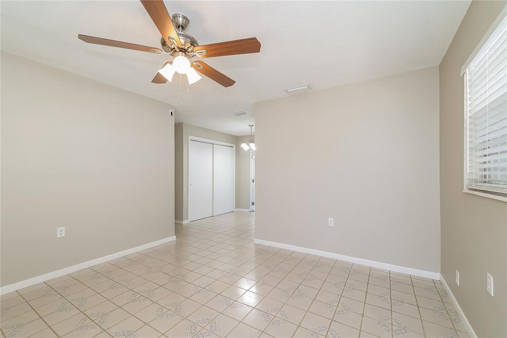 4243 Cynthia Street Orlando, FL 32811 - Photo 3 of 16 wooden floor in an empty room with a window