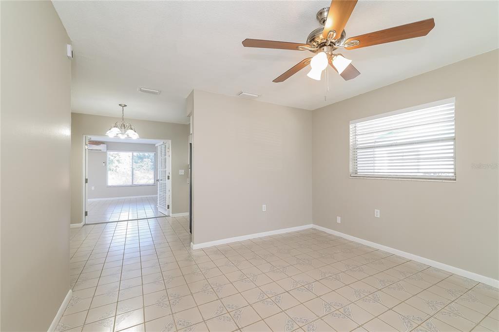 4243 Cynthia Street Orlando, FL 32811 - Photo 4 of 16 a view of an empty room with a chandelier fan