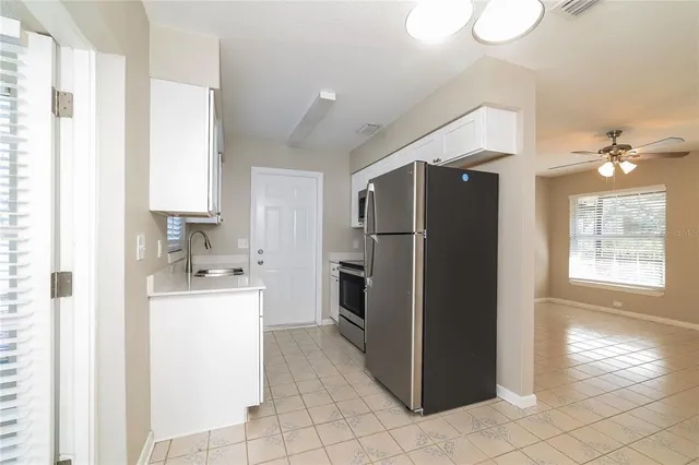 a kitchen with a refrigerator and a sink