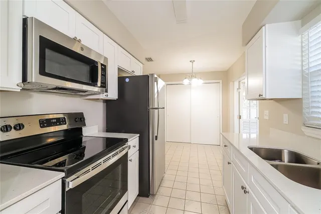 a kitchen with a sink stainless steel appliances and cabinets