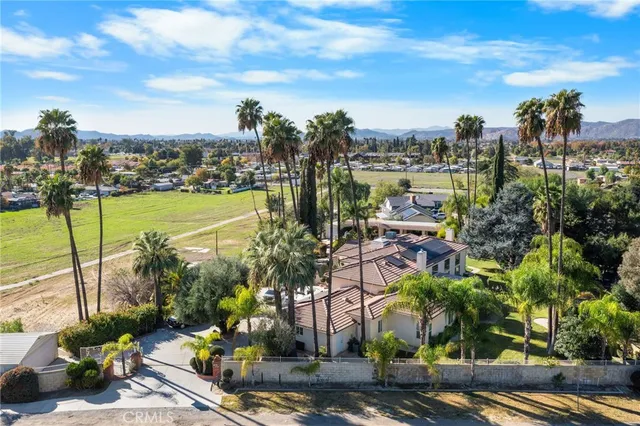 an aerial view of multiple houses with a yard