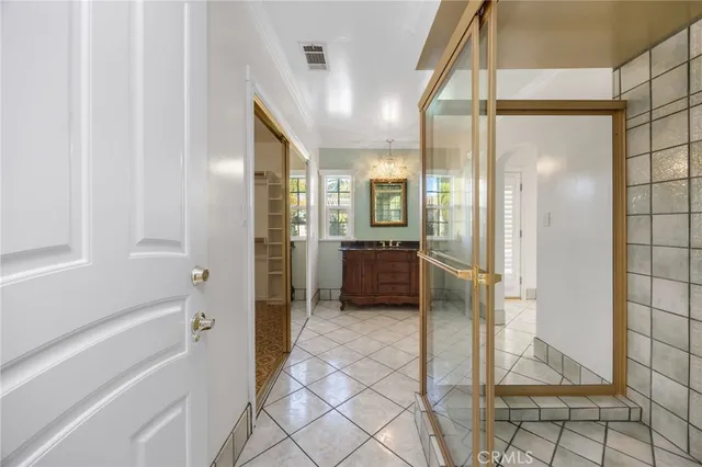 a spacious bathroom with a sink a mirror and a shower