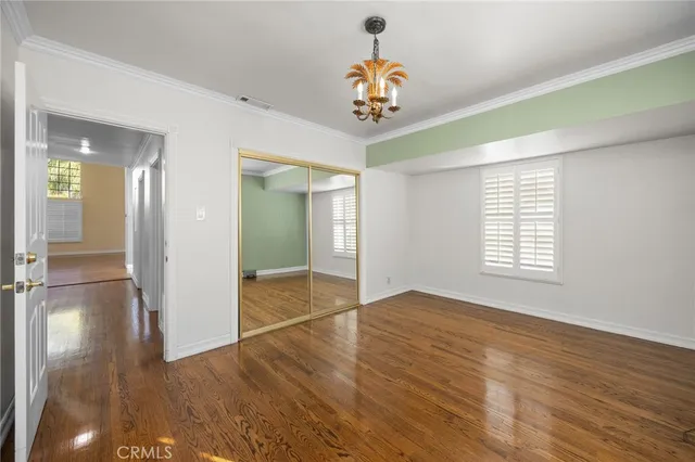 a spacious bedroom with a bed and a dresser