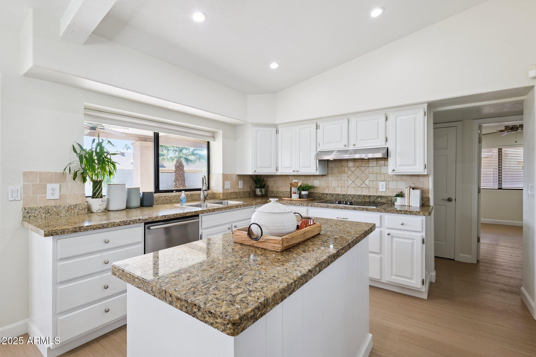 15 East Kathleen Road Phoenix, AZ 85022 - Photo 11 of 40 a kitchen with granite countertop kitchen island sink stove and white cabinets