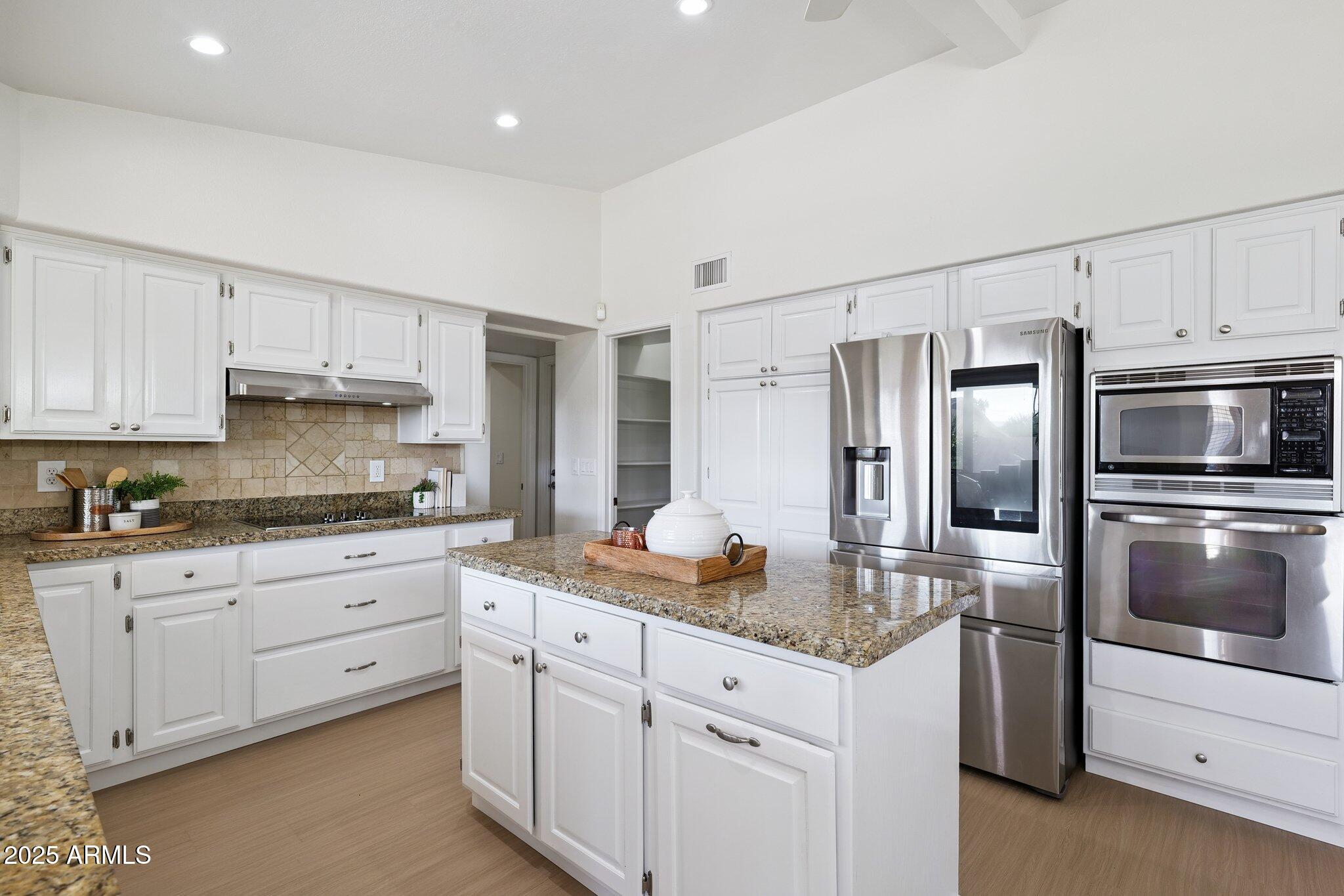 15 East Kathleen Road Phoenix, AZ 85022 - Photo 12 of 40 a kitchen with granite countertop white cabinets and stainless steel appliances
