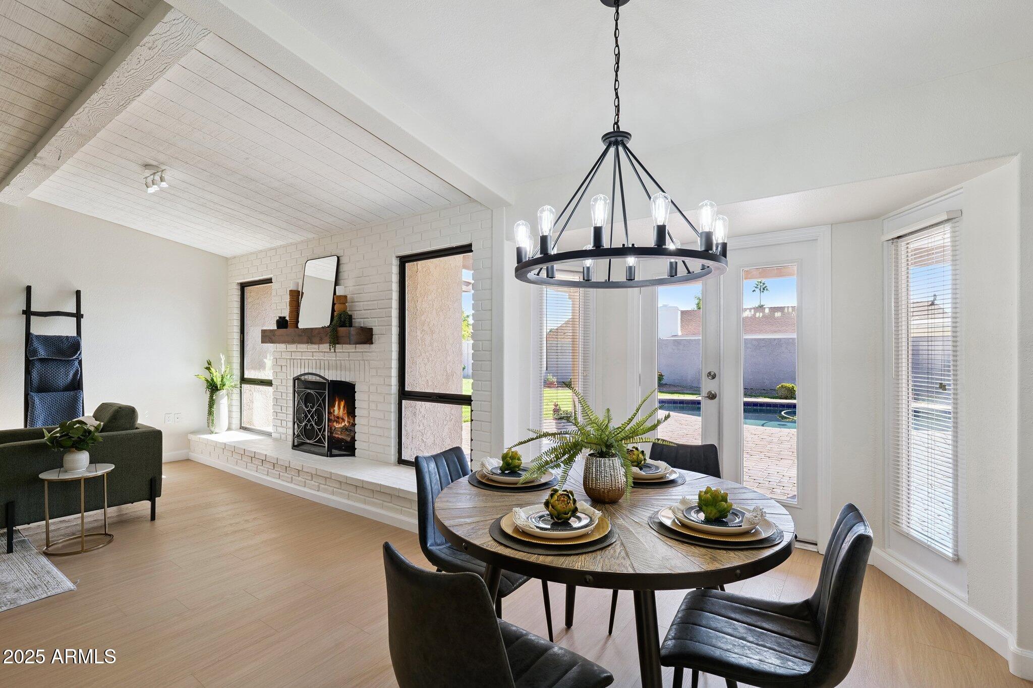 15 East Kathleen Road Phoenix, AZ 85022 - Photo 15 of 40 a view of a livingroom and dining room with furniture wooden floor a chandelier