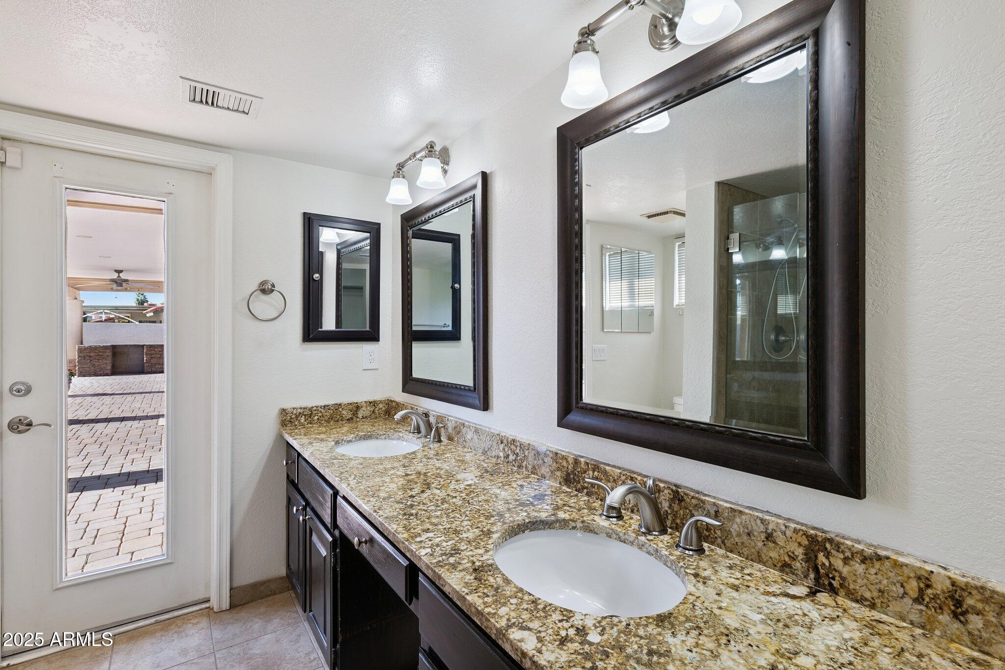 15 East Kathleen Road Phoenix, AZ 85022 - Photo 21 of 40 a bathroom with a granite countertop sink and a mirror