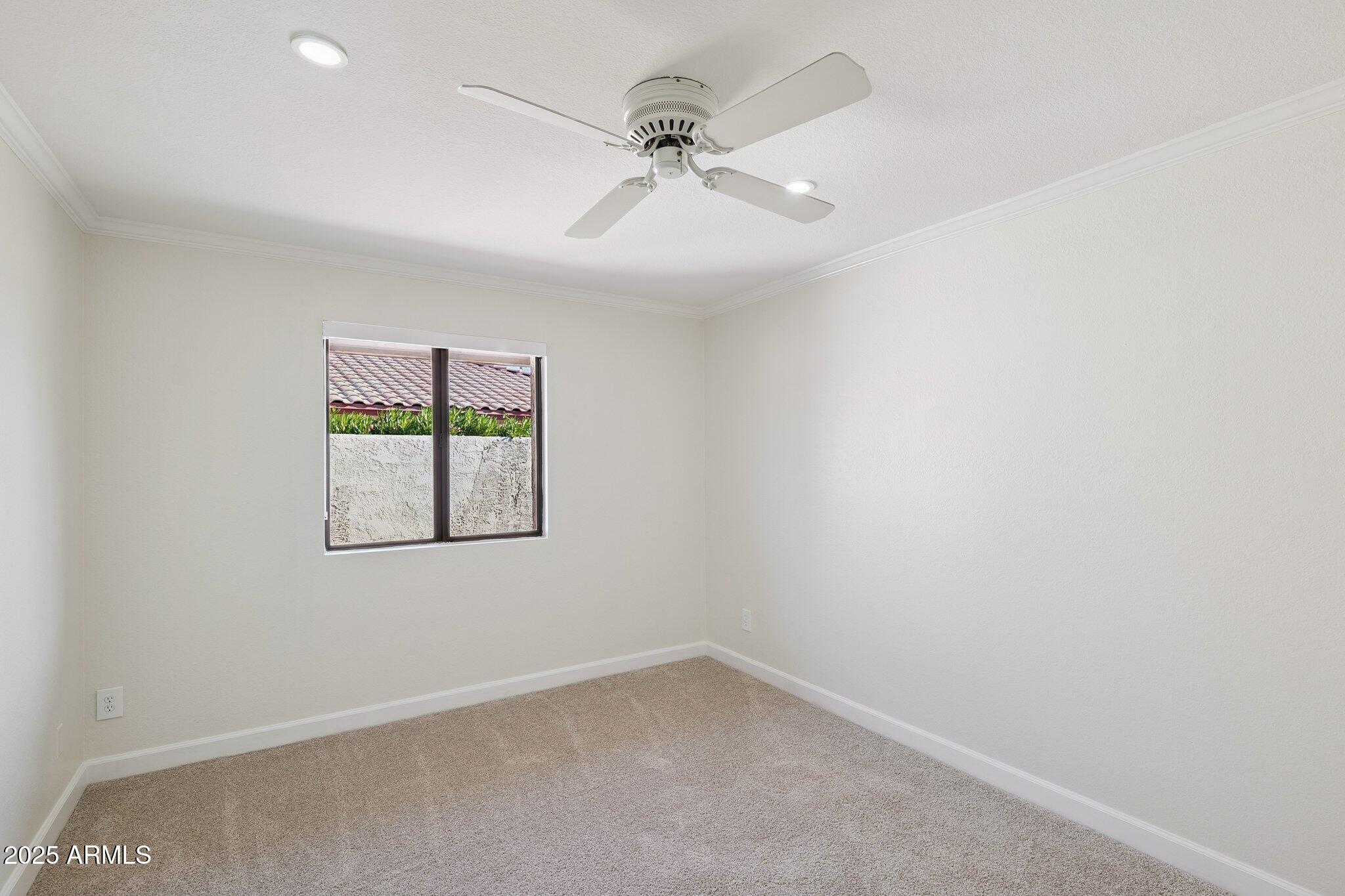 15 East Kathleen Road Phoenix, AZ 85022 - Photo 23 of 40 an empty room with a window and a fan